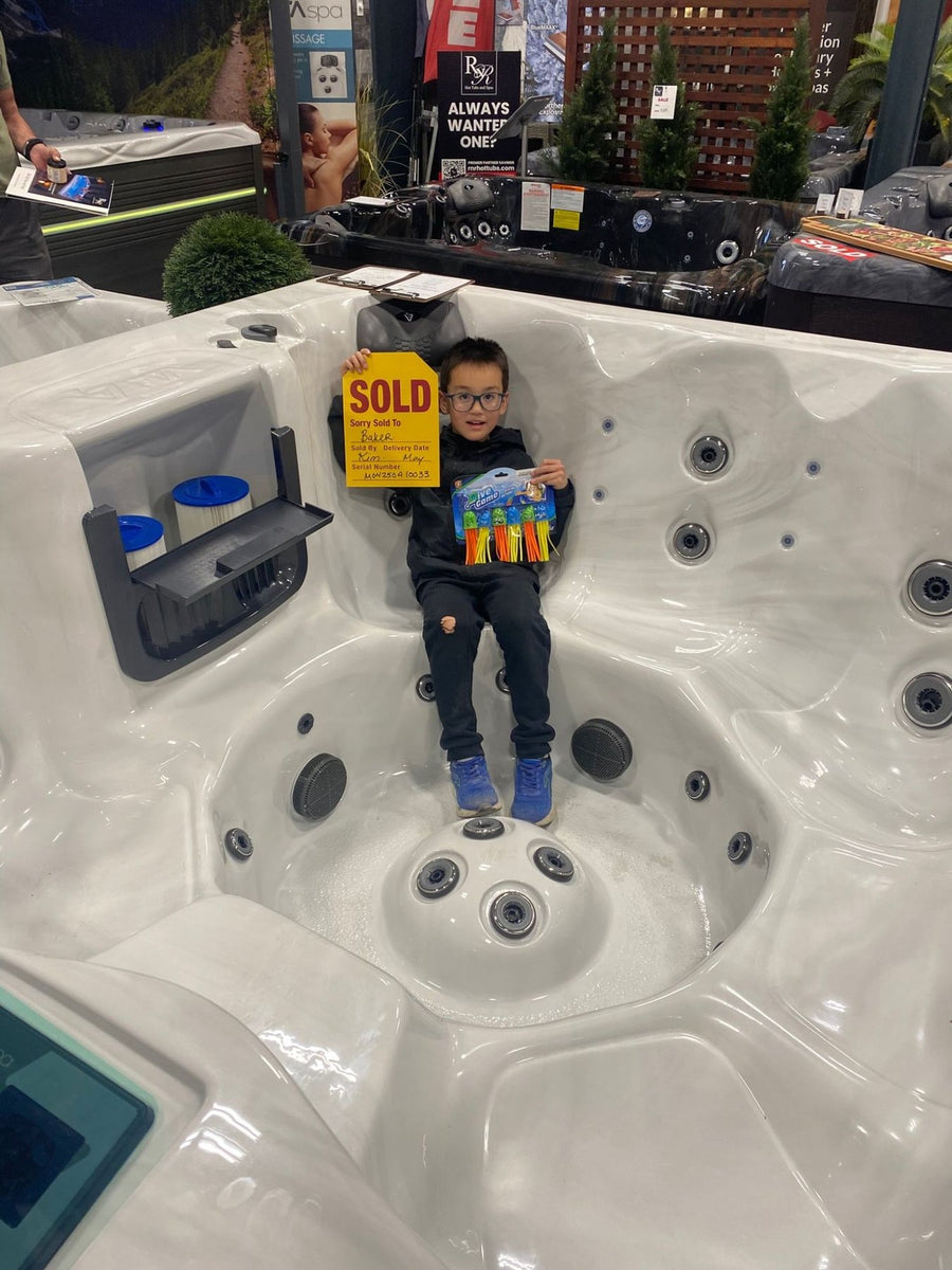 A young customer holding the sold tag for the family's spa