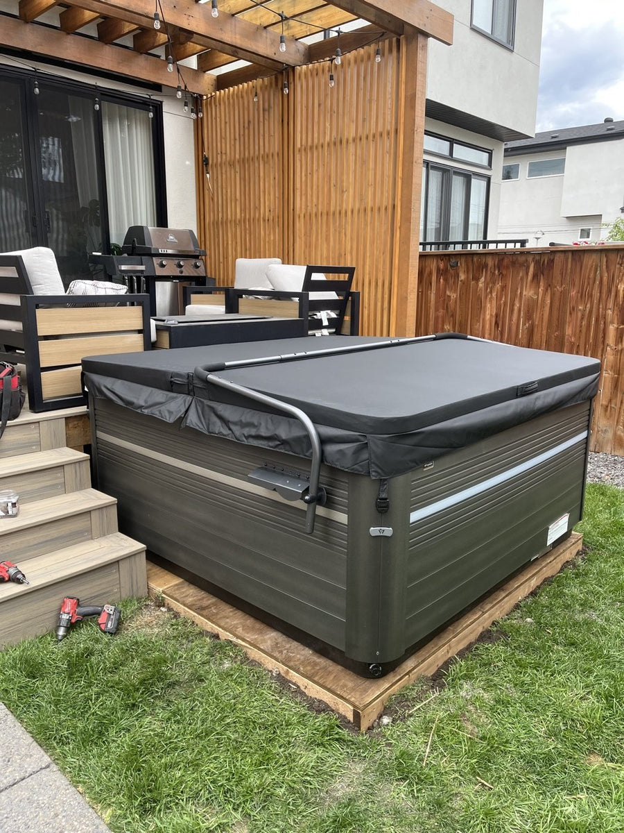 A hot tub on a deck beside the back steps