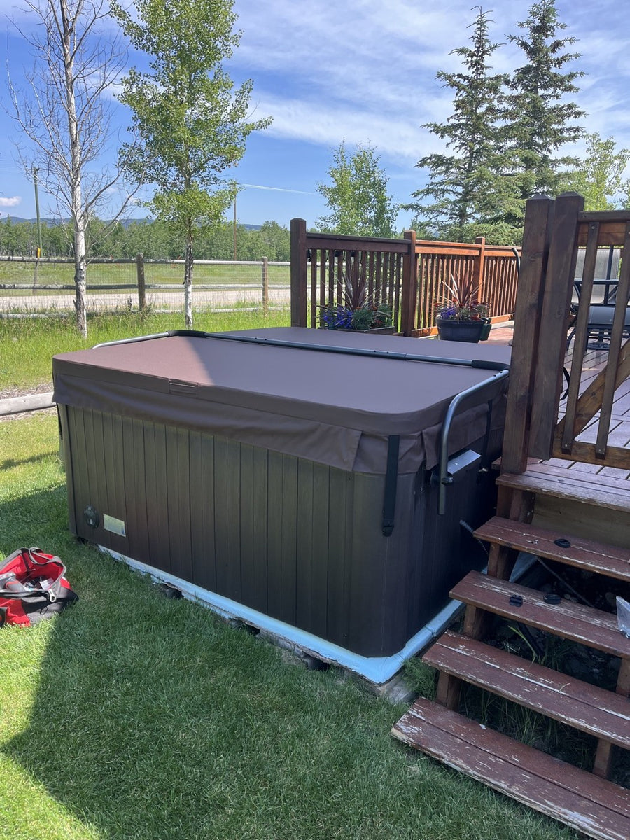 A hot tub on a deck with open sky behind it