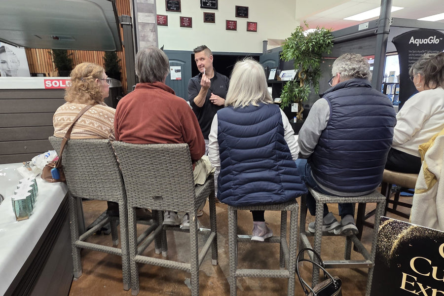 An RnR team member running a Spa School session for a group of new owners in the Calgary showroom