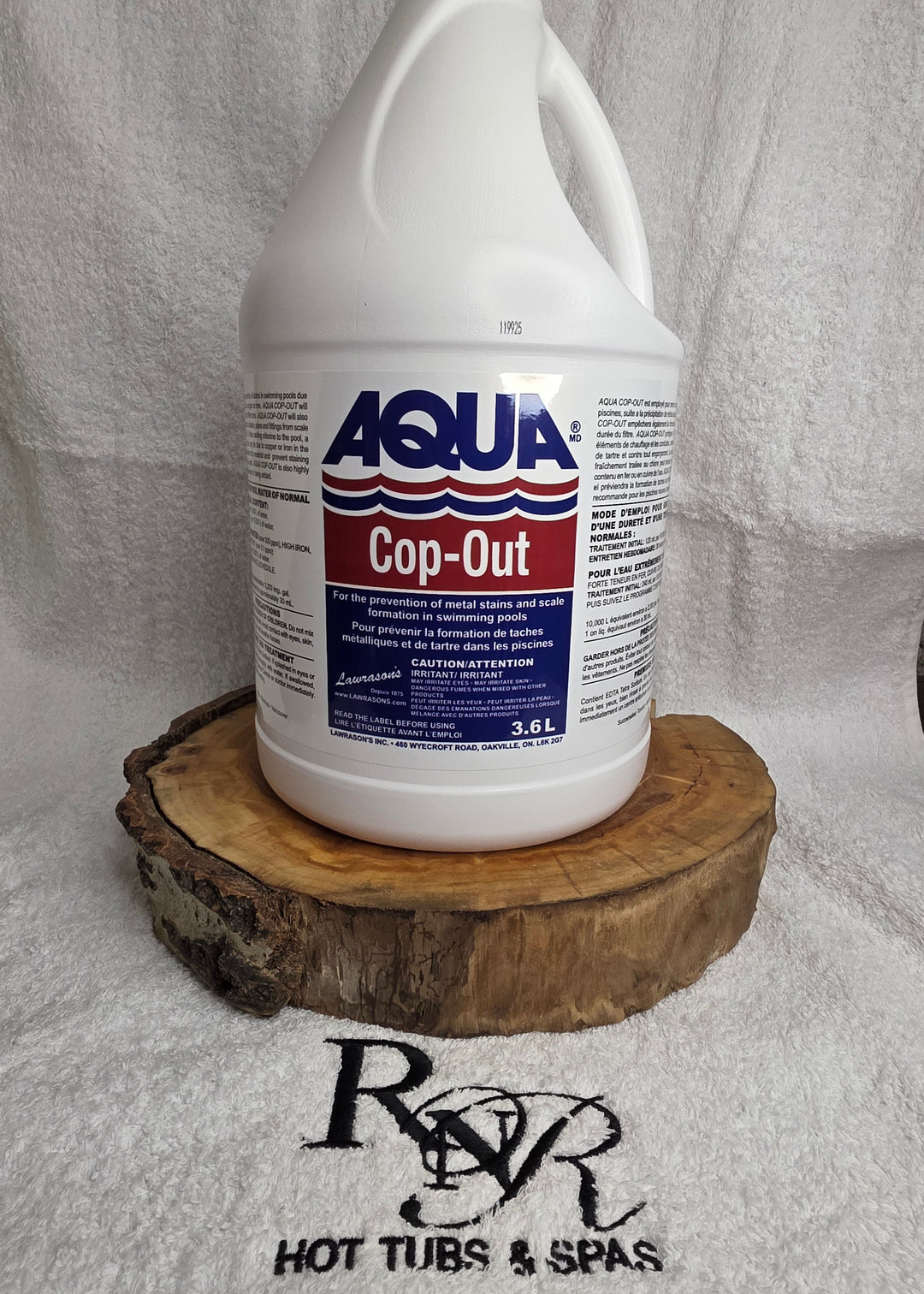 Aqua Cop-Out container with a wooden brush on a white towel, branded RnR Hot Tubs & Spas.