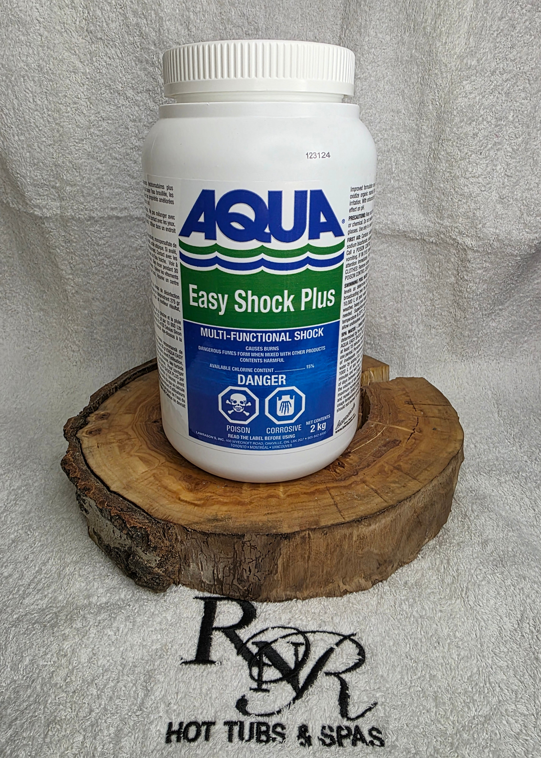 Aqua Easy Shock Plus bottle on a wooden block with a branded towel in the background