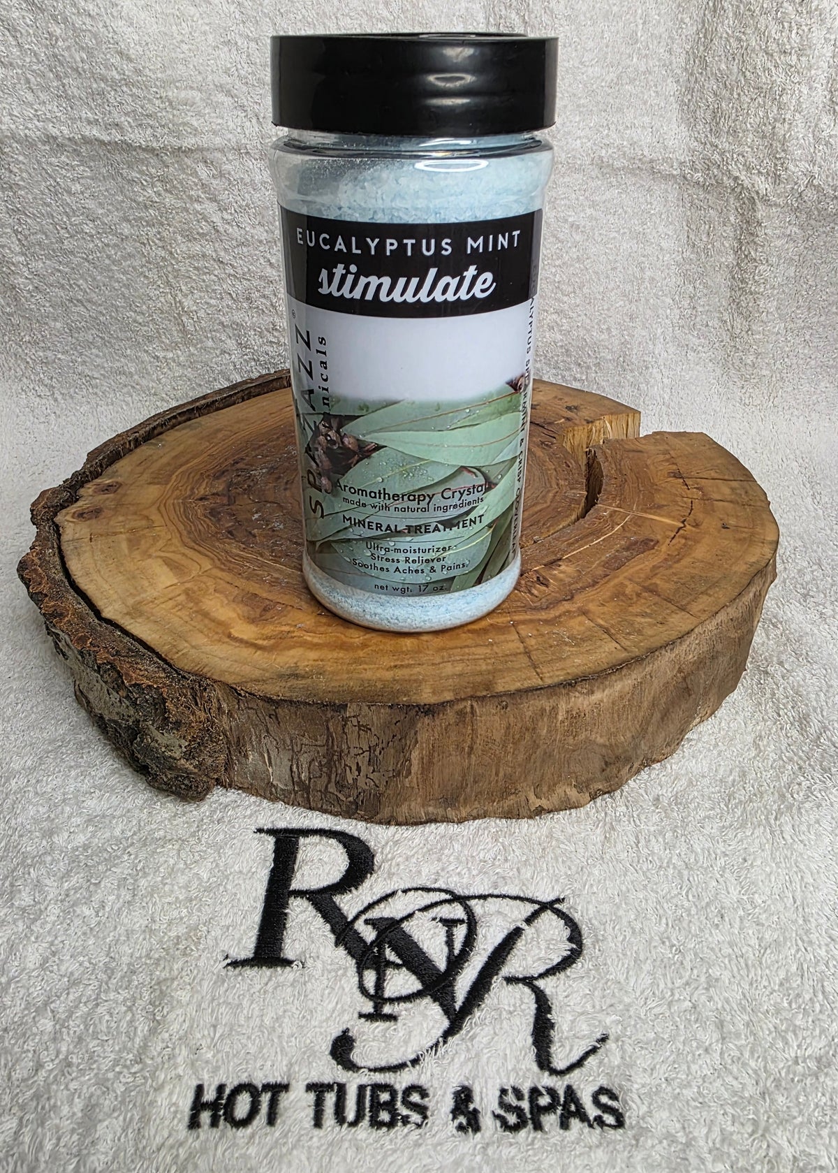 Aromatherapy crystals container on a wooden block with RnR Hot Tubs & Spas logo in the background