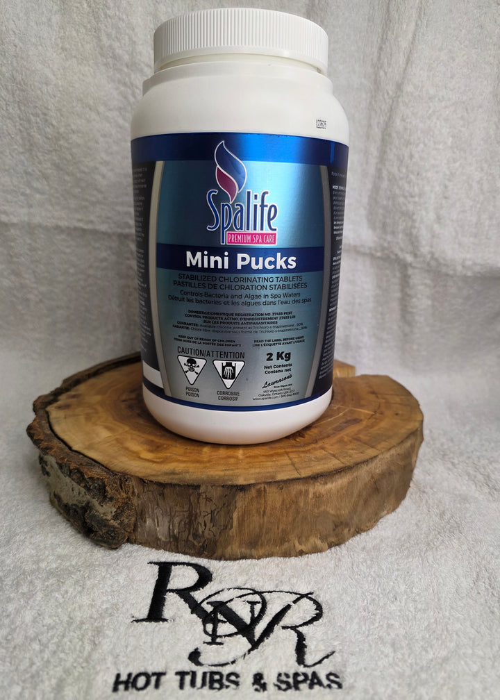 Spalife product container with a wooden brush on a towel with RnR Hot Tubs and Spas branding.