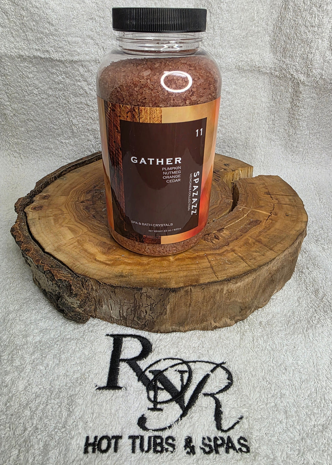 Bottle of Gather Aromatherapy Crystals  product on a wooden block with RnR Hot Tubs & Spas logo in the background.