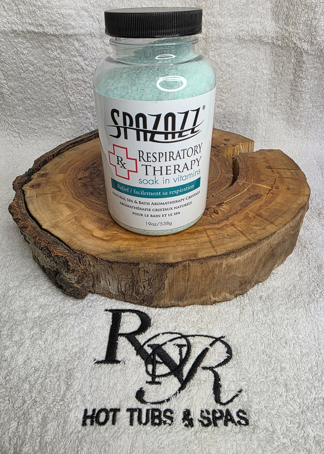 Spazazz Respiratory therapy bottle on a wooden block with RnR Hot Tubs & Spas logo in the background