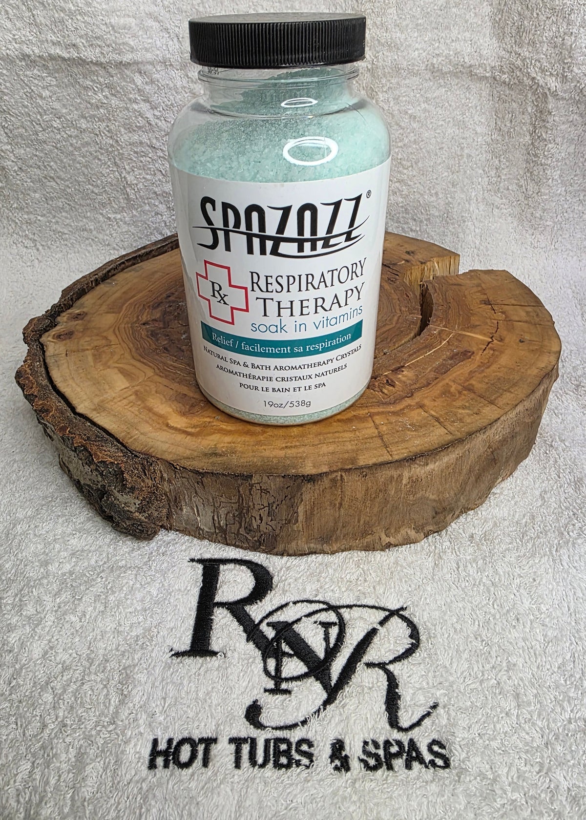 Spazazz Respiratory therapy bottle on a wooden block with RnR Hot Tubs & Spas logo in the background