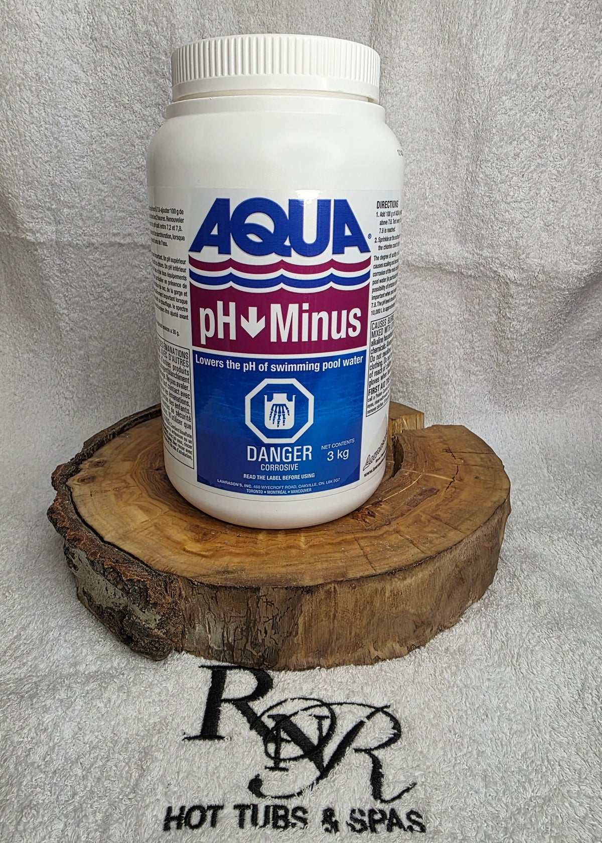 Bottle of Aqua pH Minus on a wooden block with a towel in the background