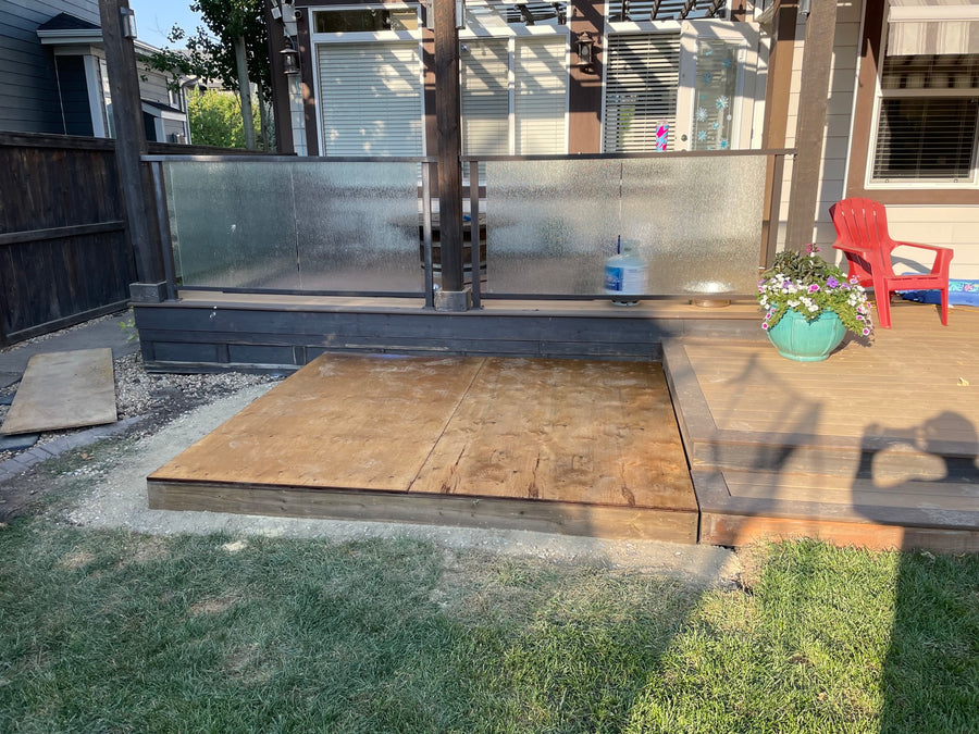 A prepared base pad beside a deck