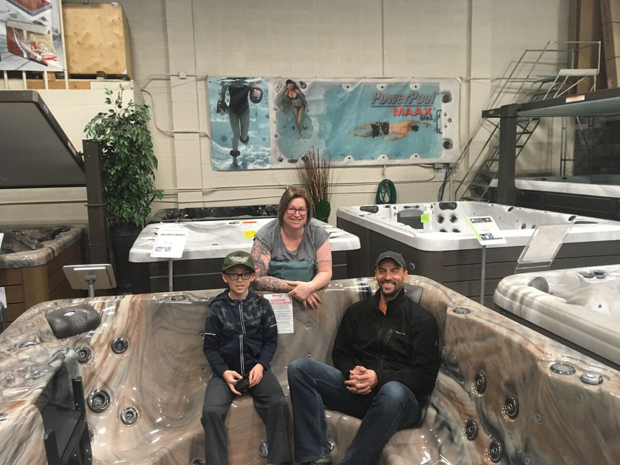 A family trying a spa at the showroom