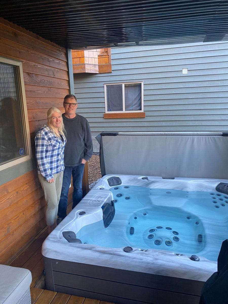 A family sitting in a spa at the showroom