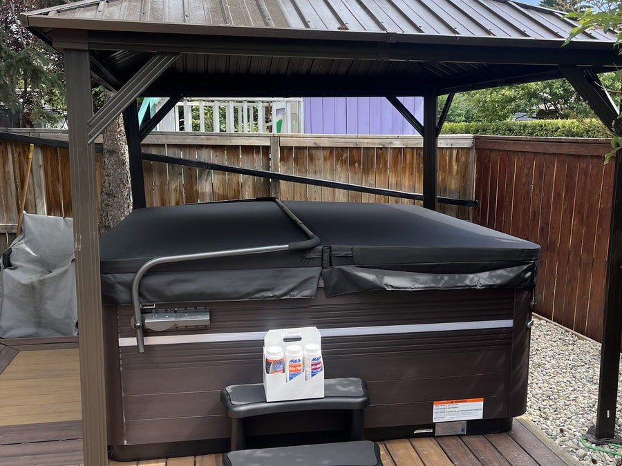 A hot tub installed on a deck under a backyard gazebo