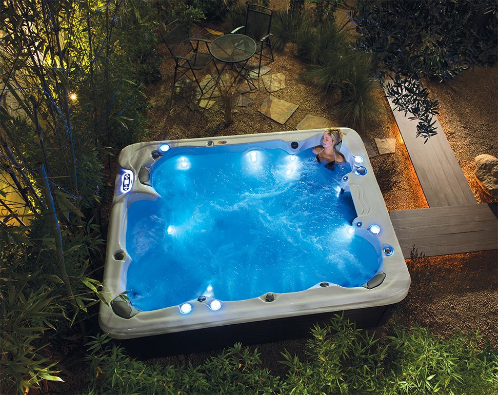 A woman relaxing in a Vita Spa hot tub. Increasing your Airbnb bookings with a hot tub. RnR Hot Tubs and Spas
